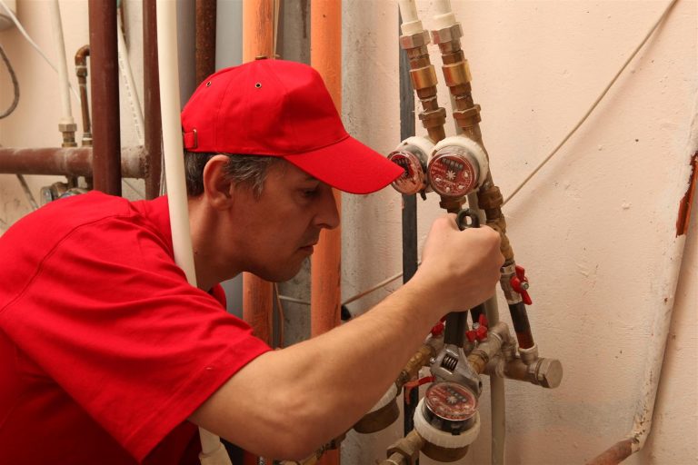 A professional plumber fixing a water pipe.